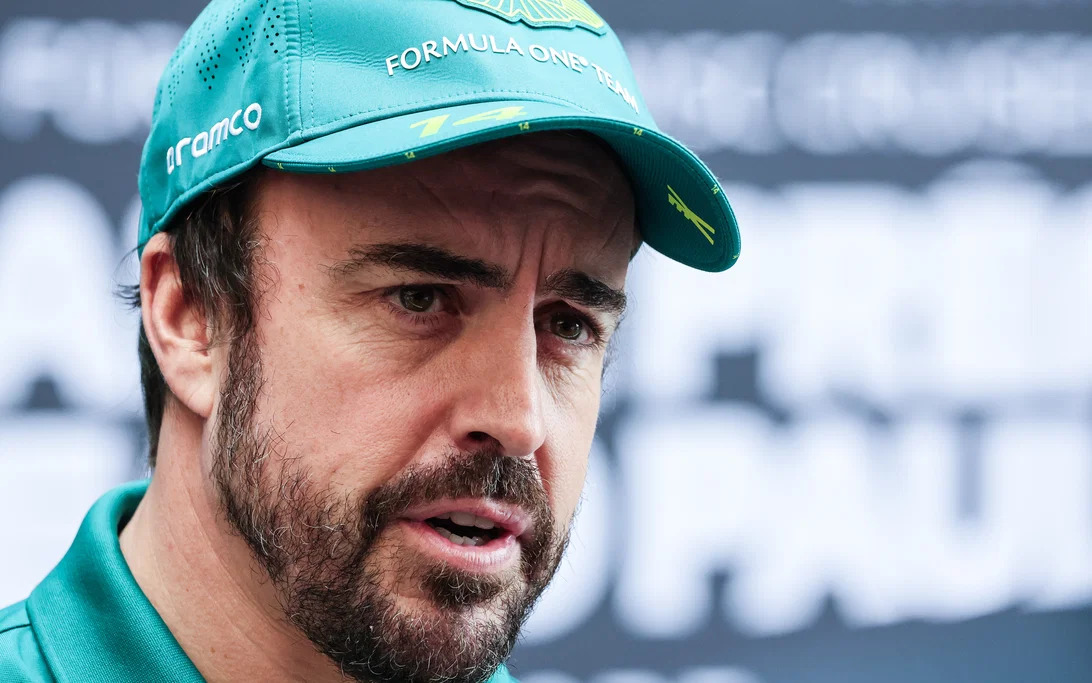Fernando Alonso guiding his F1 car through the mid-corner with a steady steering angle and minimal correction
