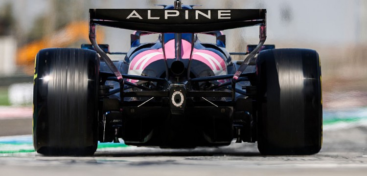 Close-up of an Alpine F1 car wheel assembly and suspension components highlighting engineering detail and material choices