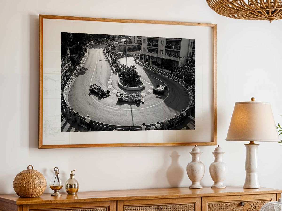Spectators on balconies and narrow streets packed with racing cars illustrating crowd energy and weekend tension