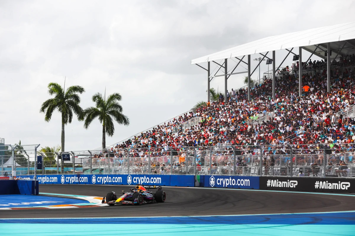 Close-up of F1 car braking hard into a Miami heavy braking zone with visible brake calipers
