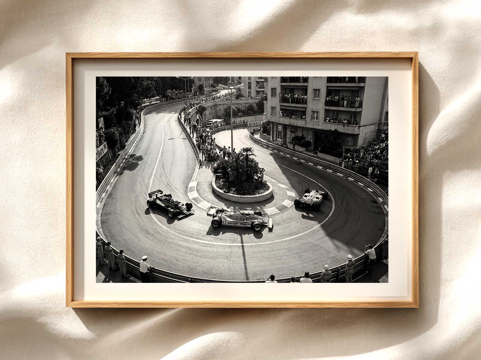 Reflections of multiple F1 cars on glossy building surfaces as they navigate a narrow Monte Carlo corner, conveying drama…