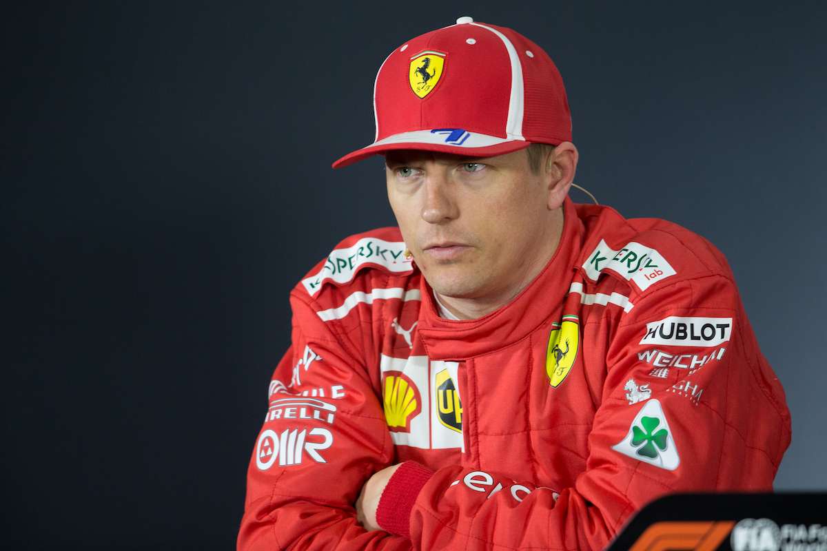 Kimi Räikkönen pushing a corner at the limit of traction with visible tire smoke