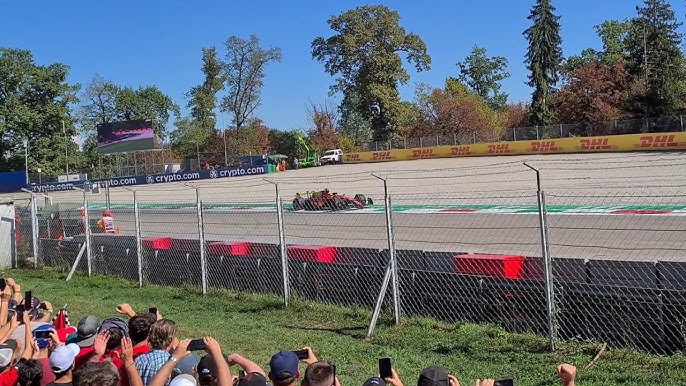 Car braking hard into the Lesmo sequence showing front suspension compression and brake heat