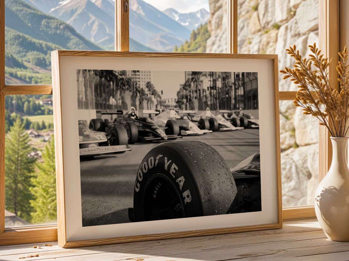 Race-day action with multiple cars negotiating a corner while tyre marbles and surface rubbering affect grip