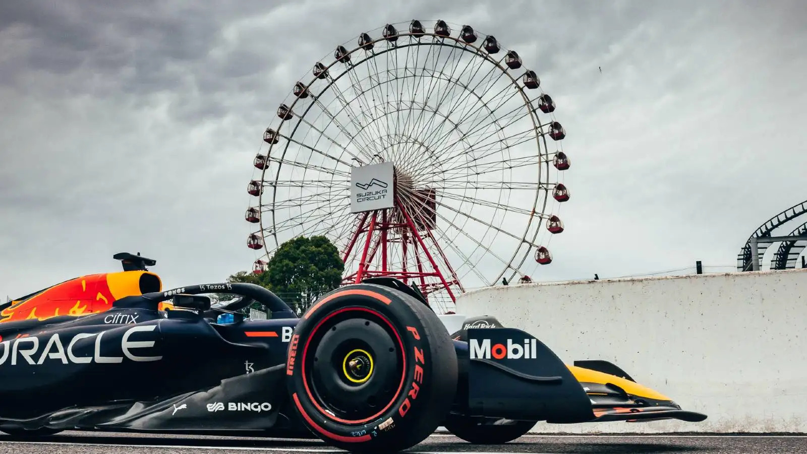 Racing cars navigating Suzuka Turns 1 to 3 with high speed and heavy lateral loads