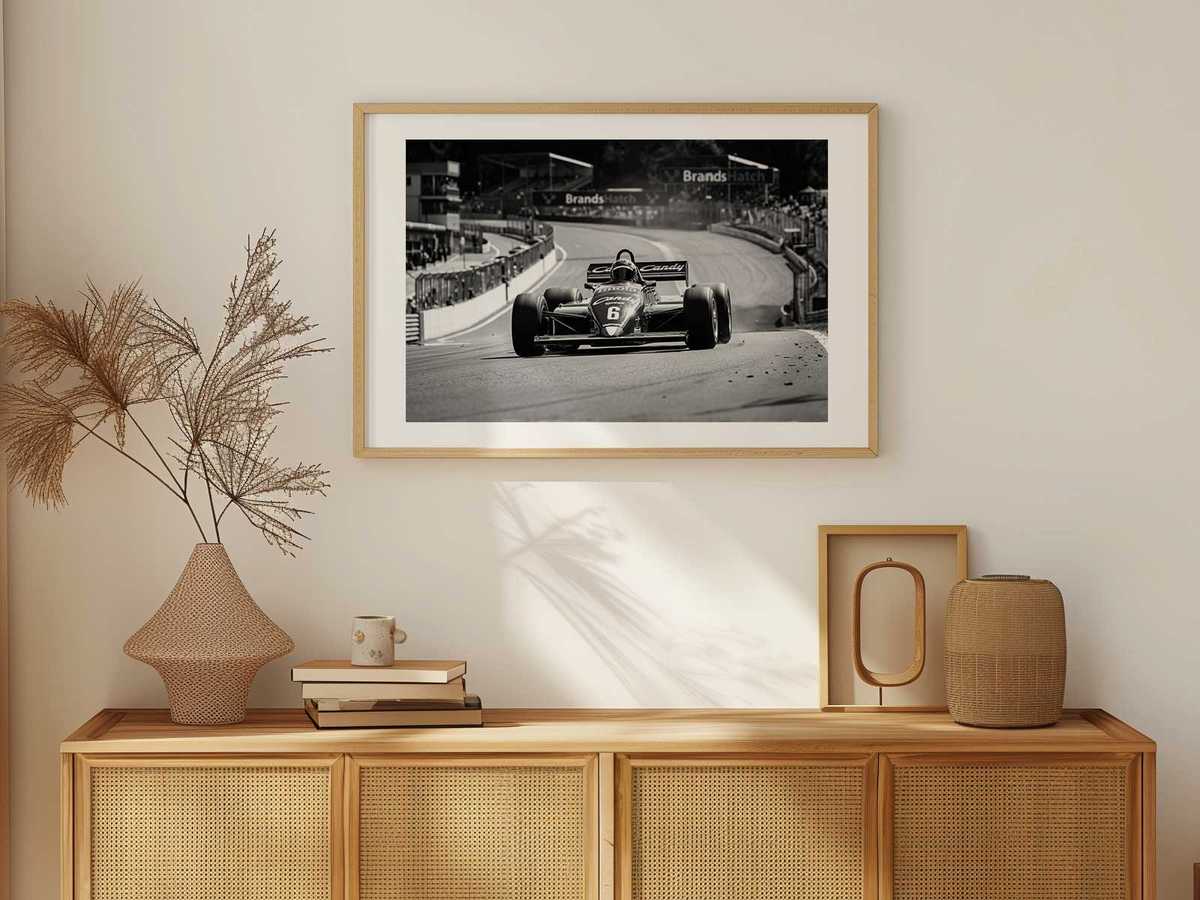 Wide compositional frame of a Tyrrell mid-race with crowd and track architecture blurred into decorative patterns
