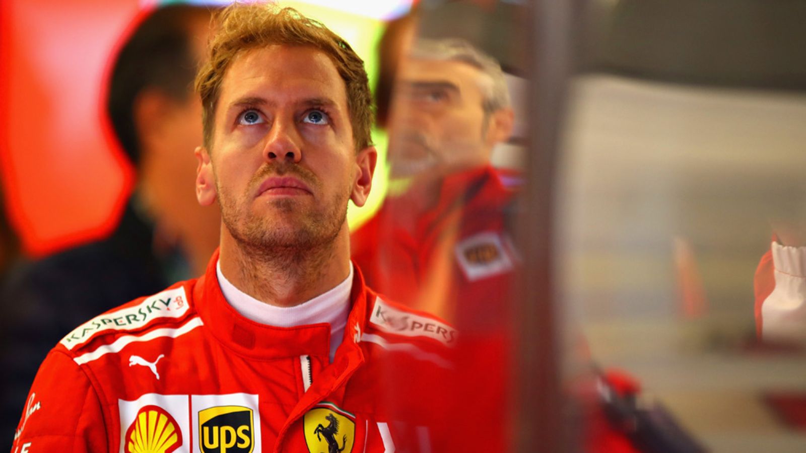 Three-quarter side shot of Vettel's car rotating through a corner under trail-braking with rear step-out visible