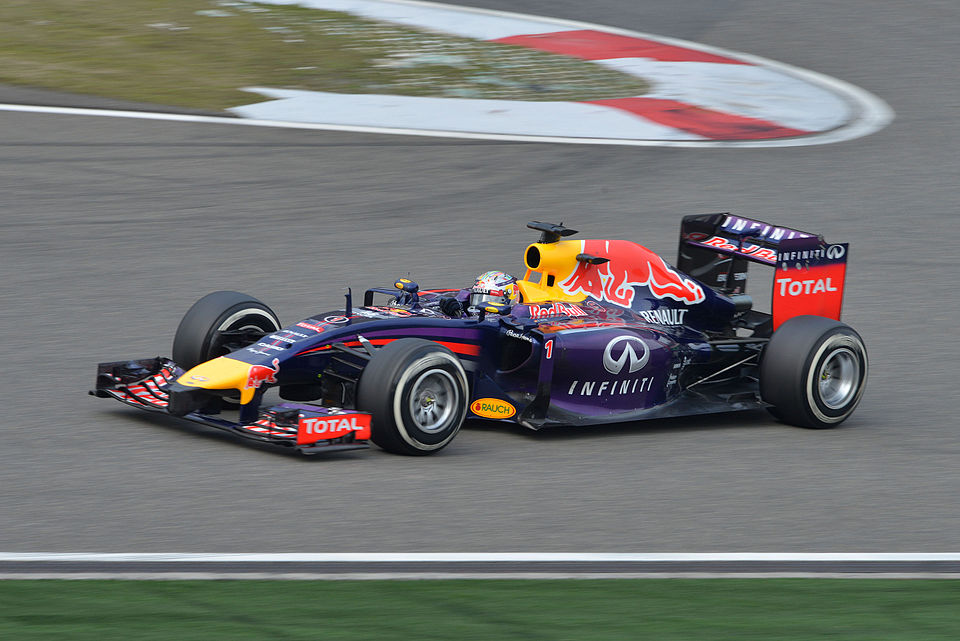 Seb Vettel executing a confident late-braking overtaking move around another car