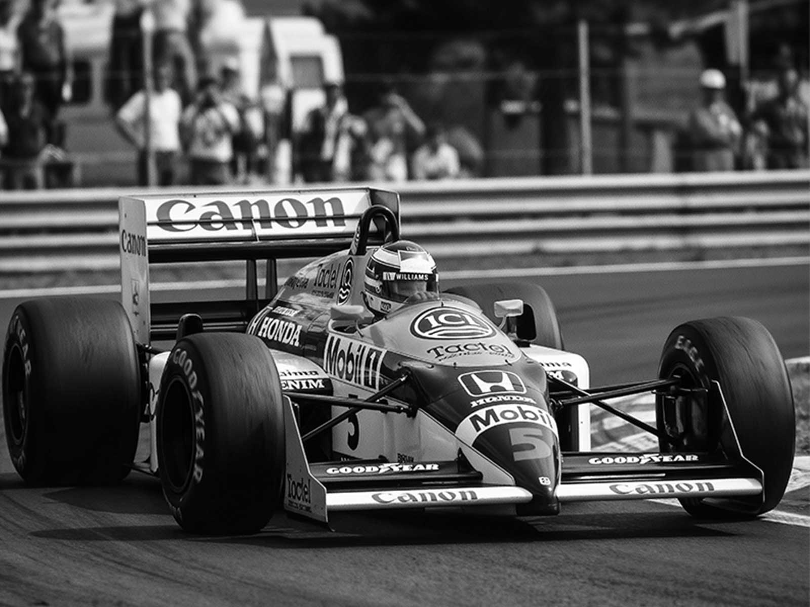 Close-up of the Williams FW11 rear wing and suspension with textured patina and retro color grading